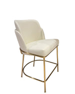 White chair with gold metal legs on a tiled floor