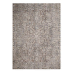 A multicolored flatwoven area rug with a geometric pattern, featuring various shades of gray, beige, and brown.