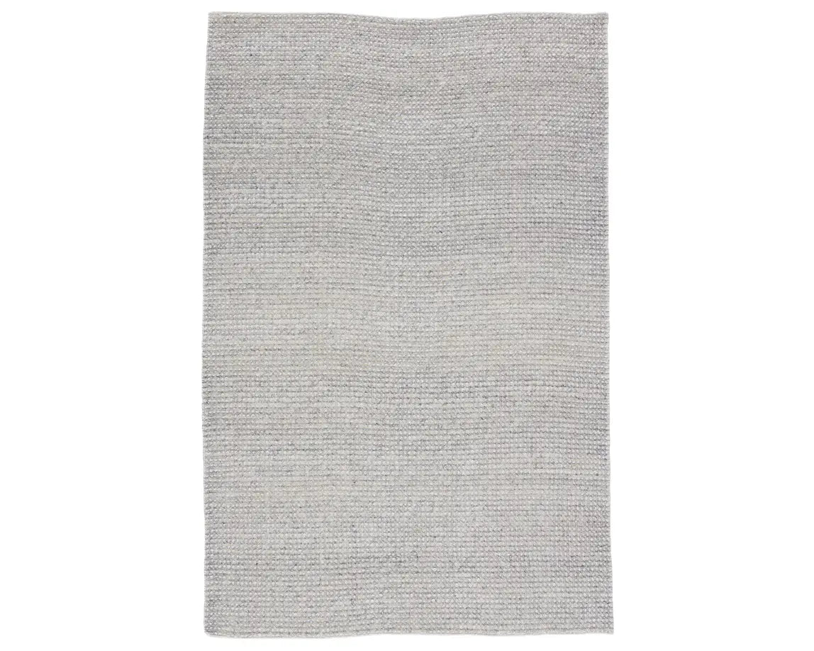 A rectangular, solid gray area rug with a textured weave.
