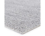 A rectangular, solid gray area rug with a textured weave.