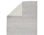 A rectangular, solid gray area rug with a textured weave.