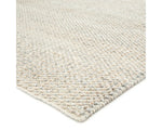 A rectangular area rug in ivory and gray colors, handwoven from 100% polyester yarn.