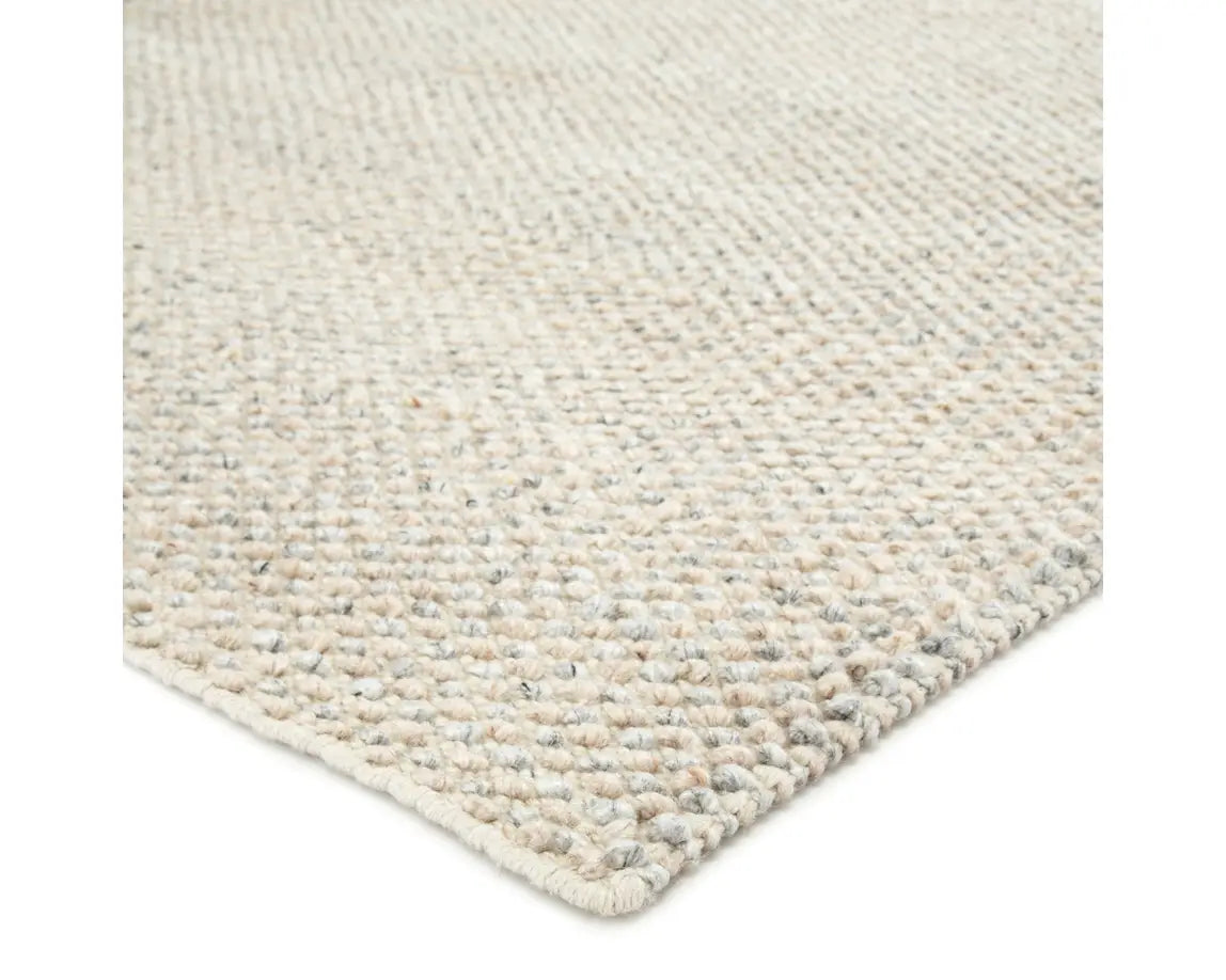A rectangular area rug in ivory and gray colors, handwoven from 100% polyester yarn.