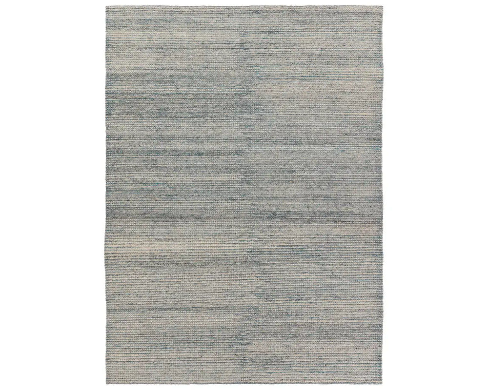 A rectangular area rug with a striped pattern in shades of blue and gray.