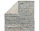 A rectangular area rug with a striped pattern in shades of blue and gray.