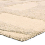 Beige area rug with a textured pattern on a white background