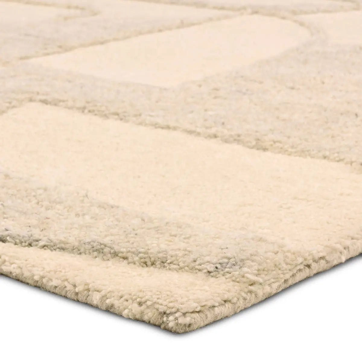 Beige area rug with a textured pattern on a white background