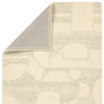 Beige and gray patterned rug corner on a white background
