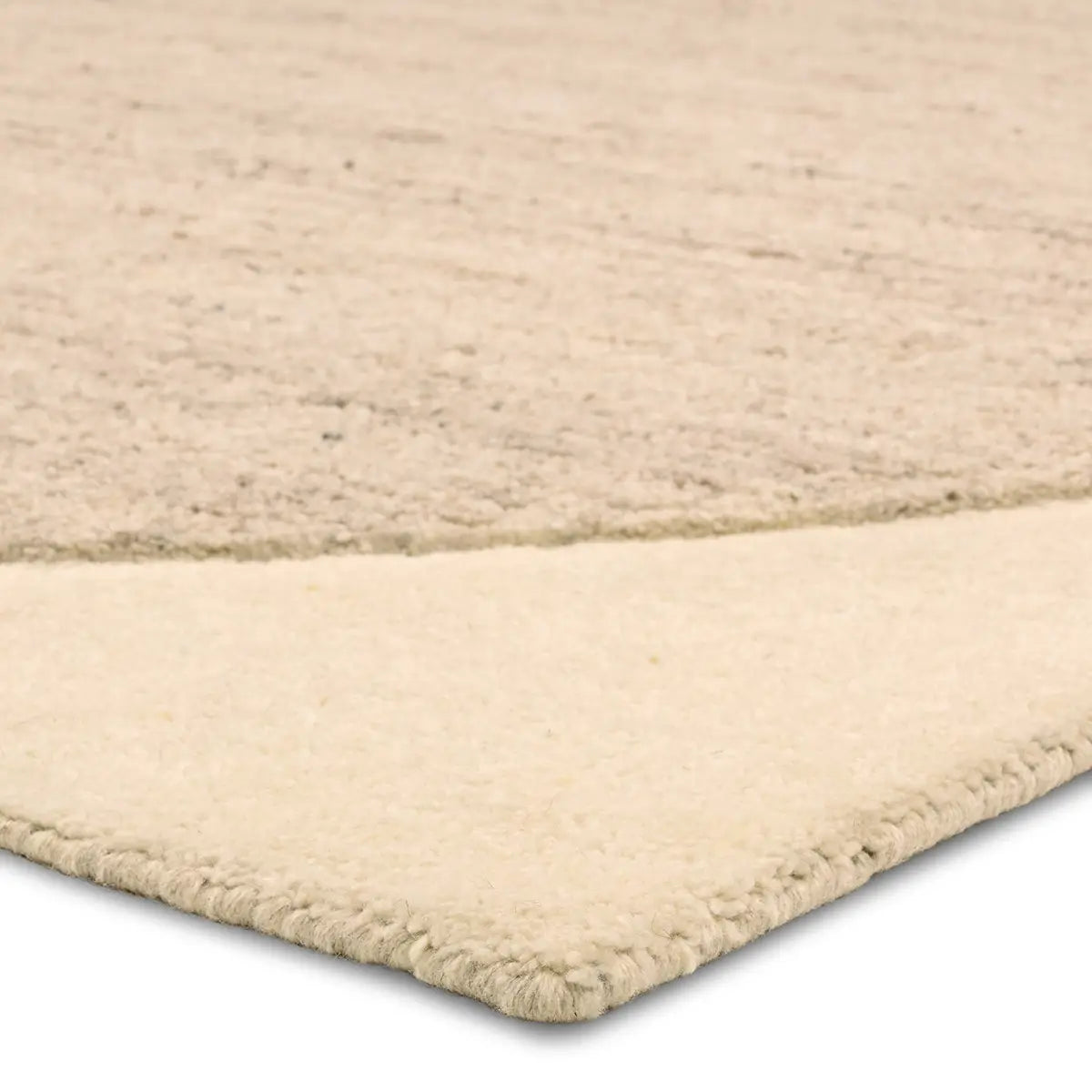 Beige woven rug corner on a white background