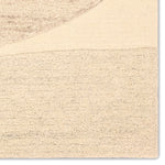Beige textured rug with a subtle pattern