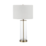 Table lamp with white shade and brass base on a white background