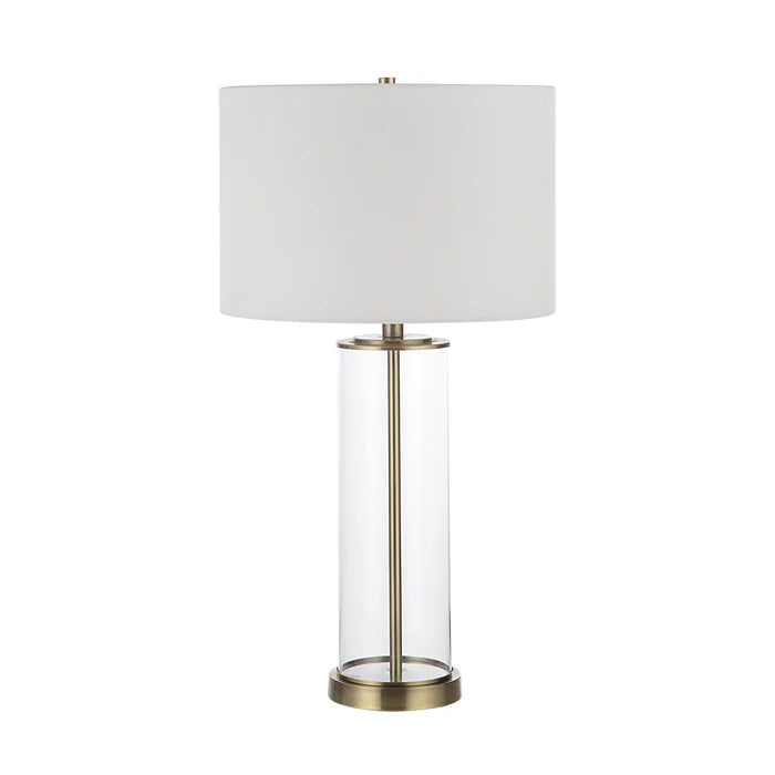 Table lamp with white shade and brass base on a white background