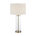Table lamp with white shade and brass base on a white background