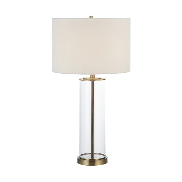 Table lamp with white shade and brass base on a white background