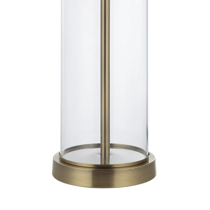 Cylindrical glass lantern with brass base on a white background