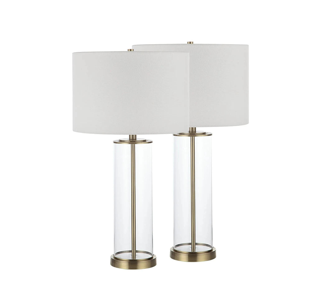 Two table lamps with clear glass bases and gold-colored metal hardware, paired with white lampshades.