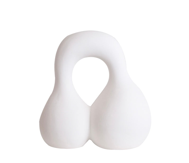 An off-white sculpture with a smooth, curved surface, depicting a stylized animal or object with a dual-tone color scheme.