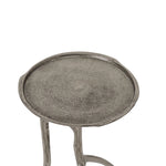 Round metal side table on a white background