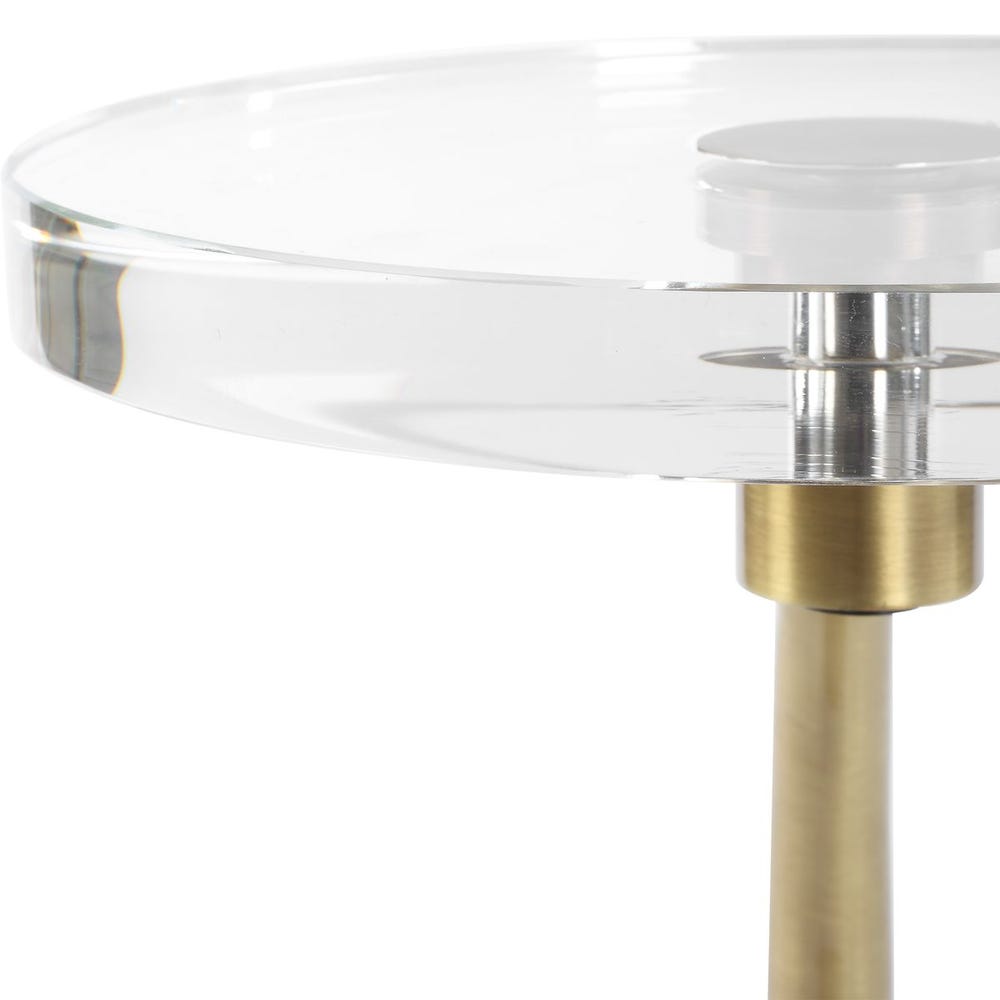 Glass table with a gold metal base on a white background