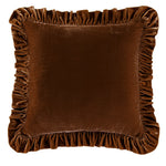 Brown velvet pillow with ruffled edges on a white background