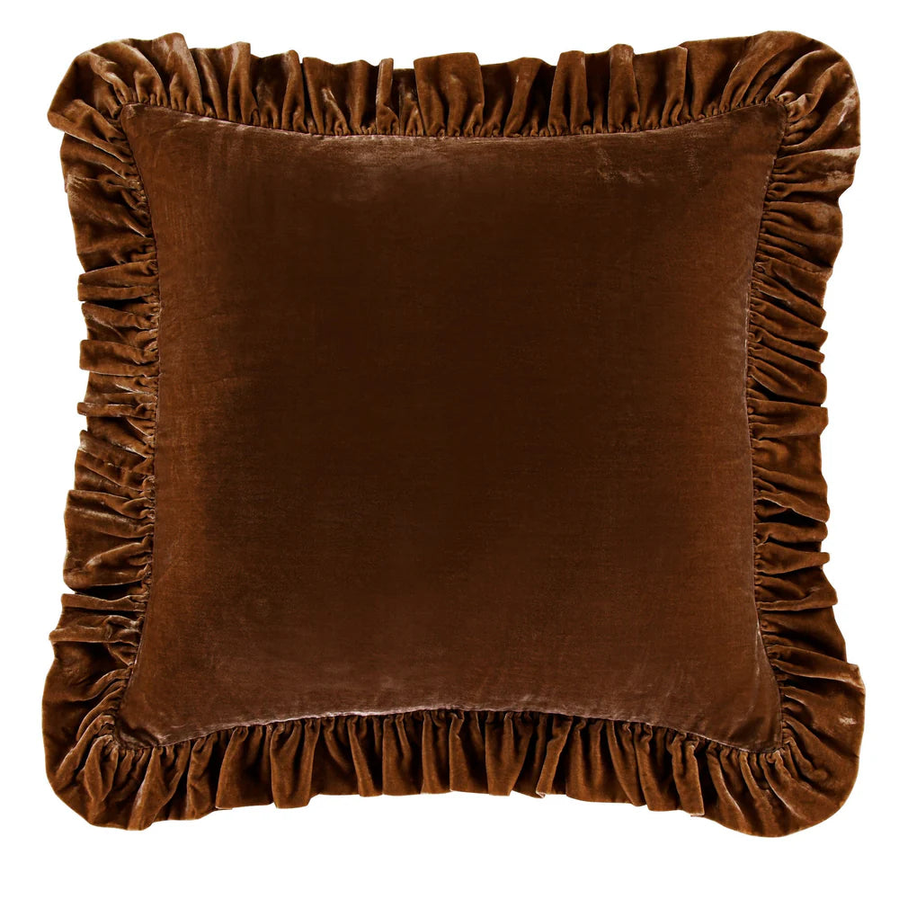 Brown velvet pillow with ruffled edges on a white background