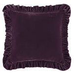 Purple velvet pillow with ruffled edges on a white background
