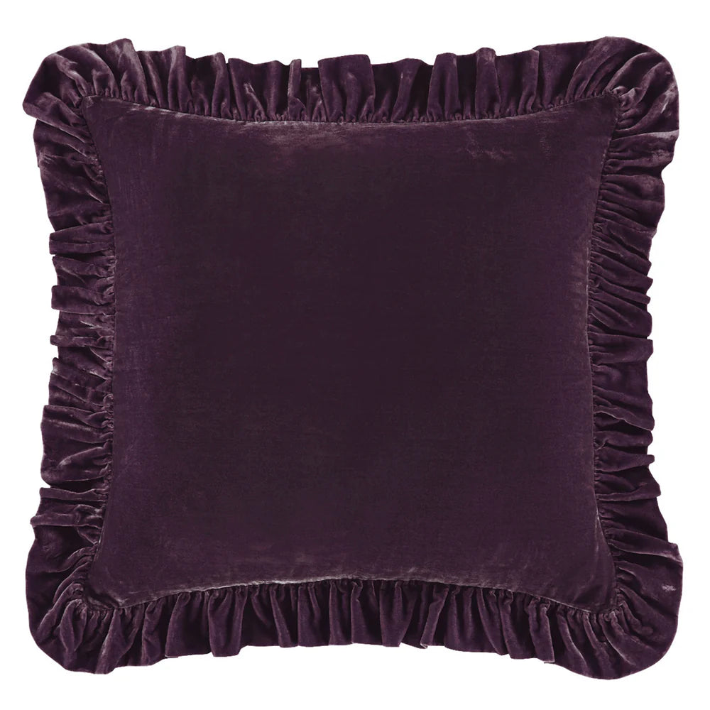 Purple velvet pillow with ruffled edges on a white background