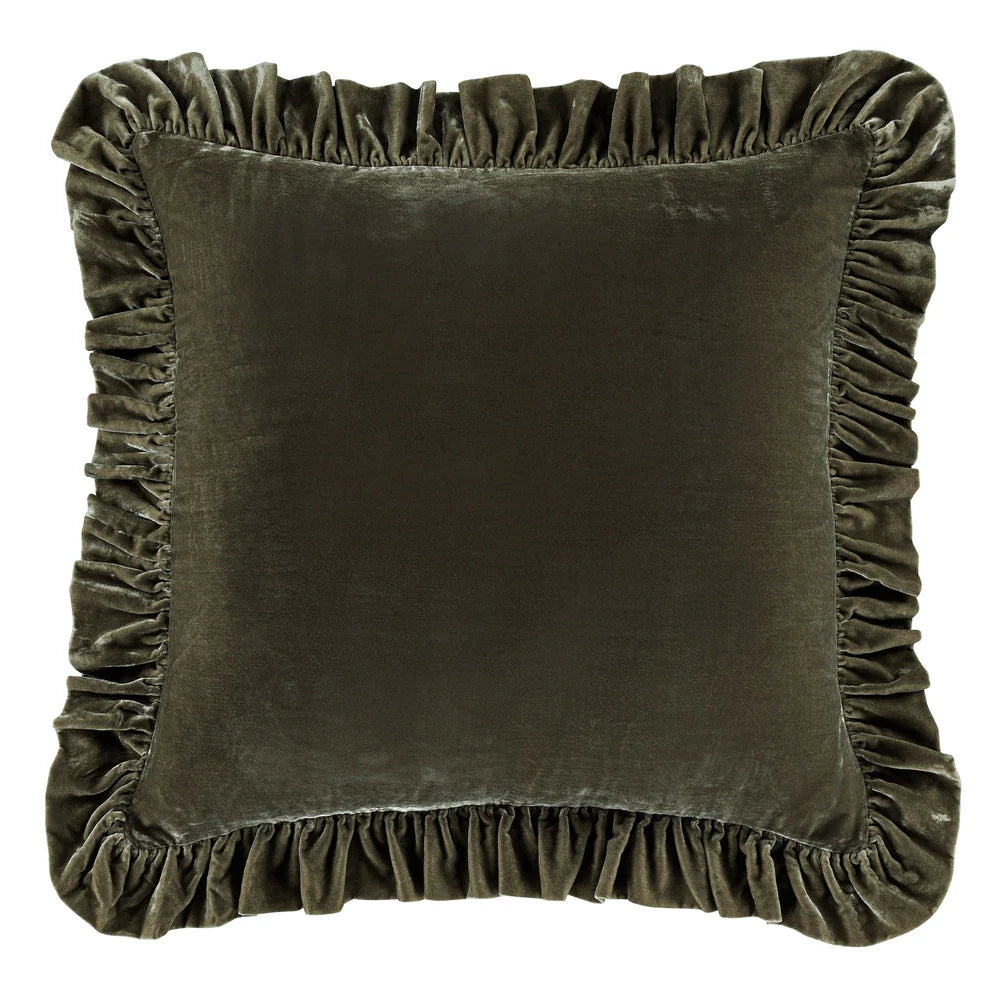 Brown velvet pillow with ruffled edges on a white background