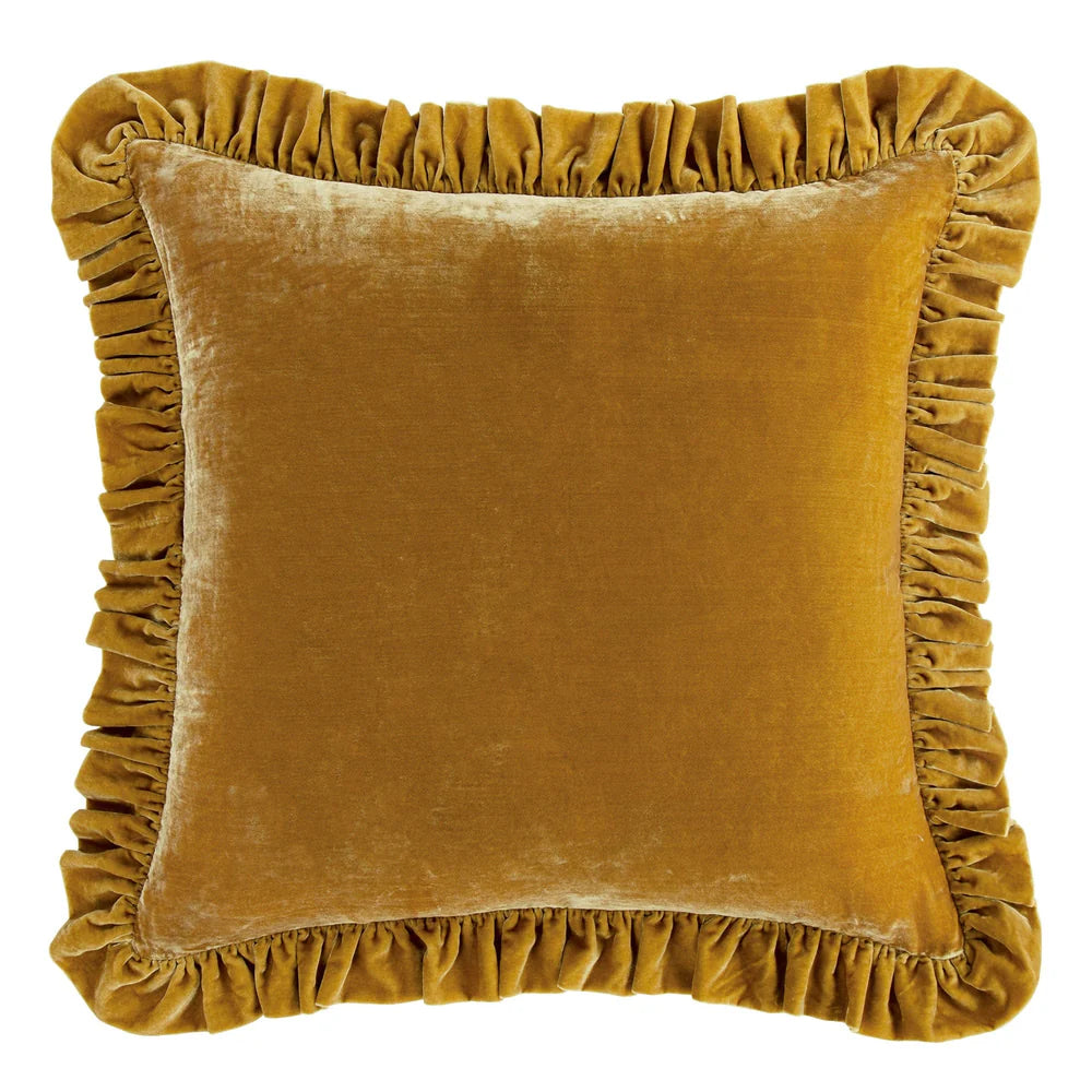 Mustard yellow velvet pillow with ruffled edges on a white background