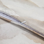 Close-up of a zipper on a textured fabric surface