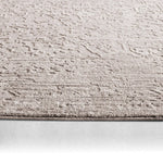 Textured beige rug on a white background
