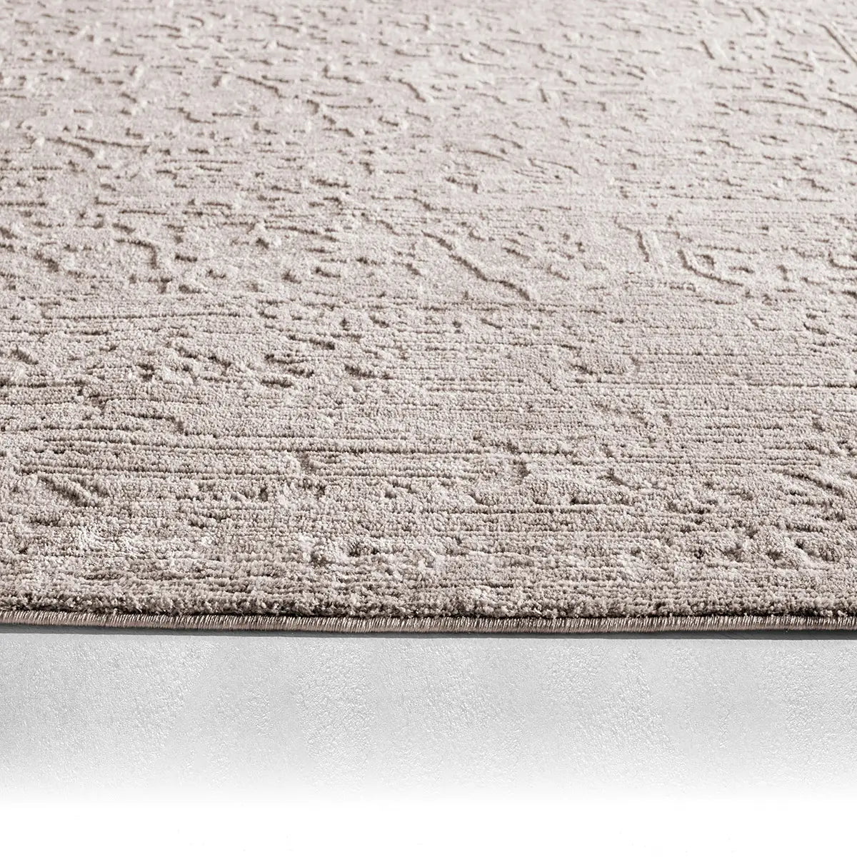 Textured beige rug on a white background