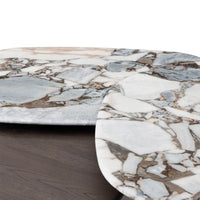 Close-up of a marble table with a dark wood floor.