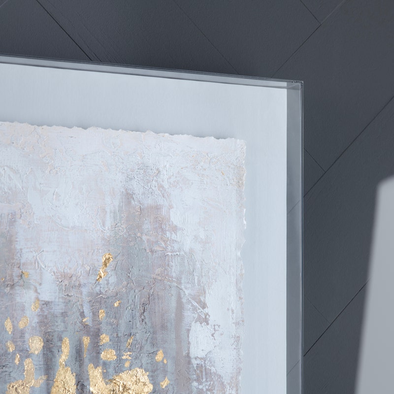 Acrylic wall art featuring an abstract design with gold, gray, and white colors.