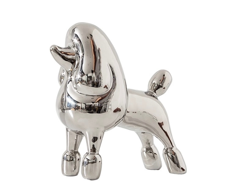 A sliver poodle decorative sculpture with a white background