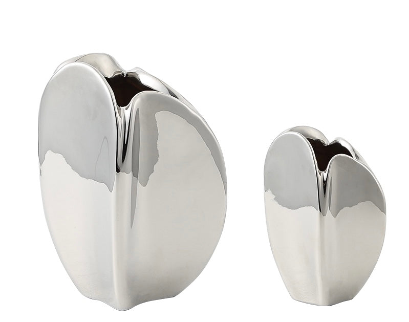 Two silver porcelain vases of different sizes with a smooth finish and a reflective surface.