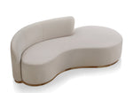 A beige curved sofa with a modern design, featuring a deep seat and a smooth, continuous curve.