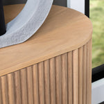 Wooden side table with a textured surface and a decorative object on top