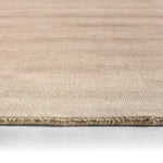 Beige rug with a textured pattern on a white background