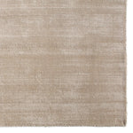 Textured beige rug on a white background
