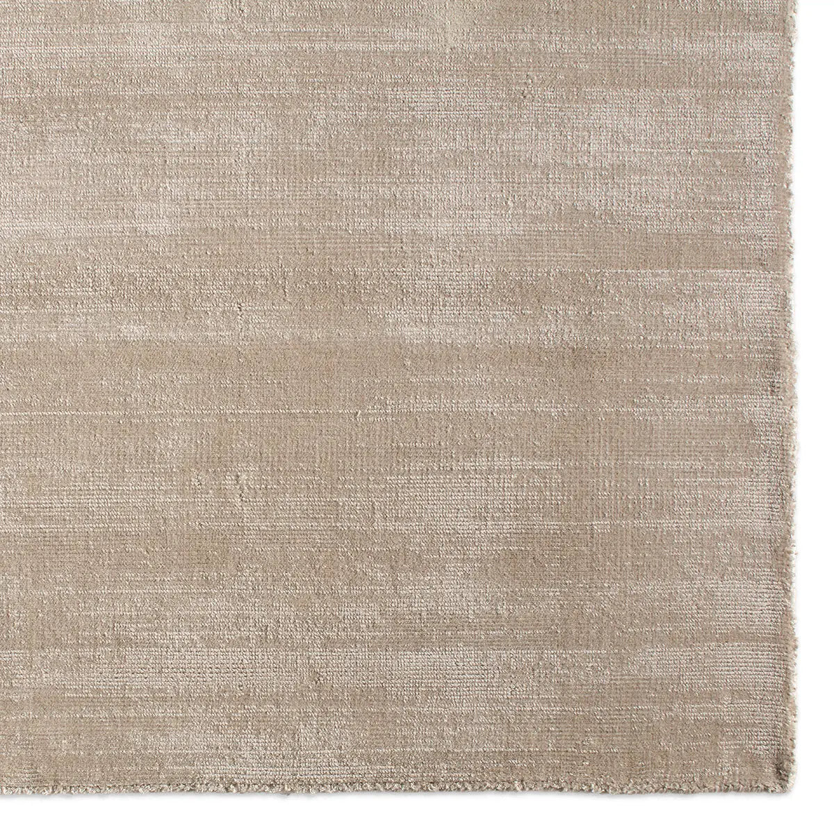Textured beige rug on a white background