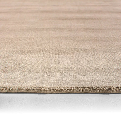 Beige rug with a textured pattern on a white background