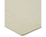 A beige area rug with a textured weave, laid out flat.
