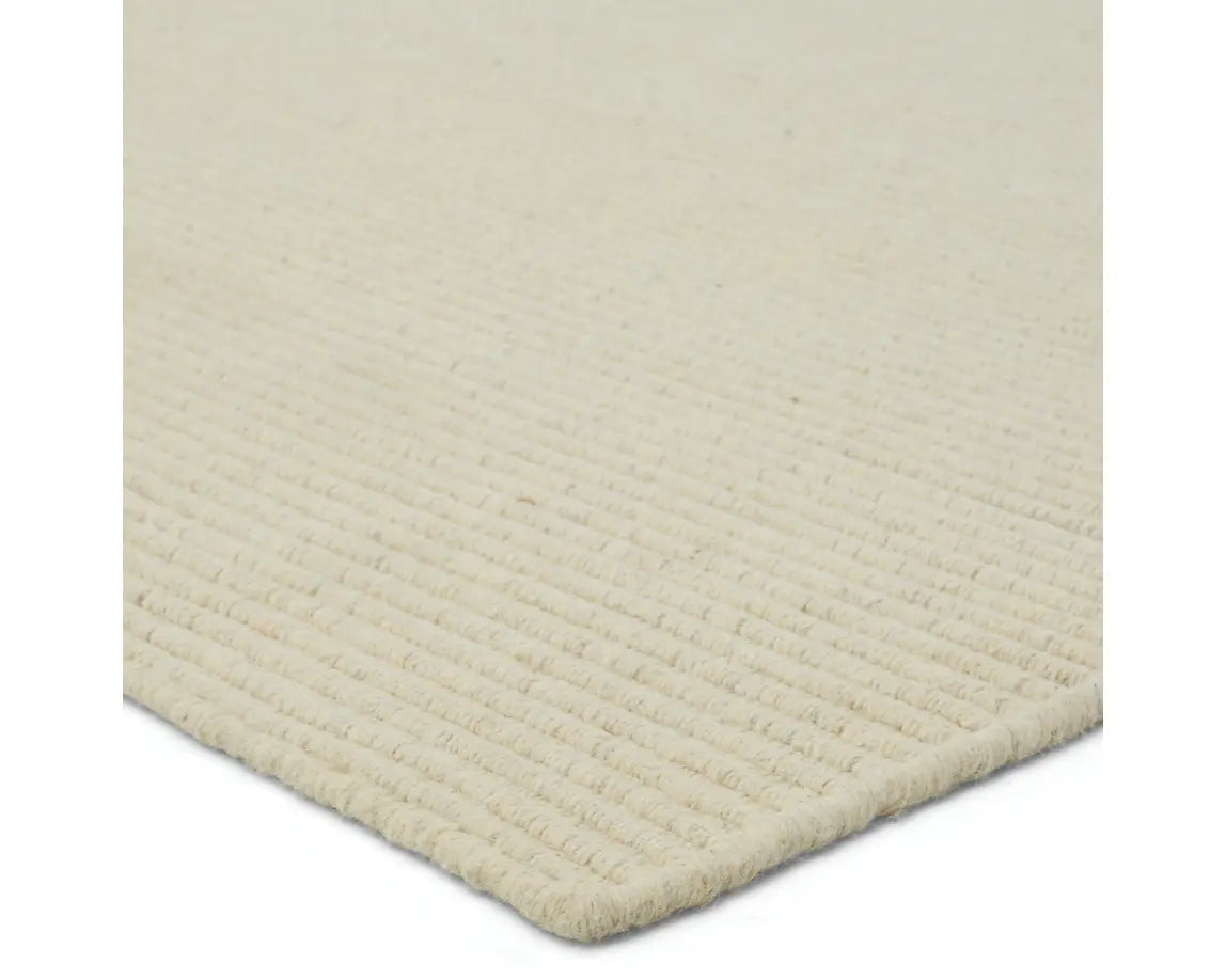 A beige area rug with a textured weave, laid out flat.