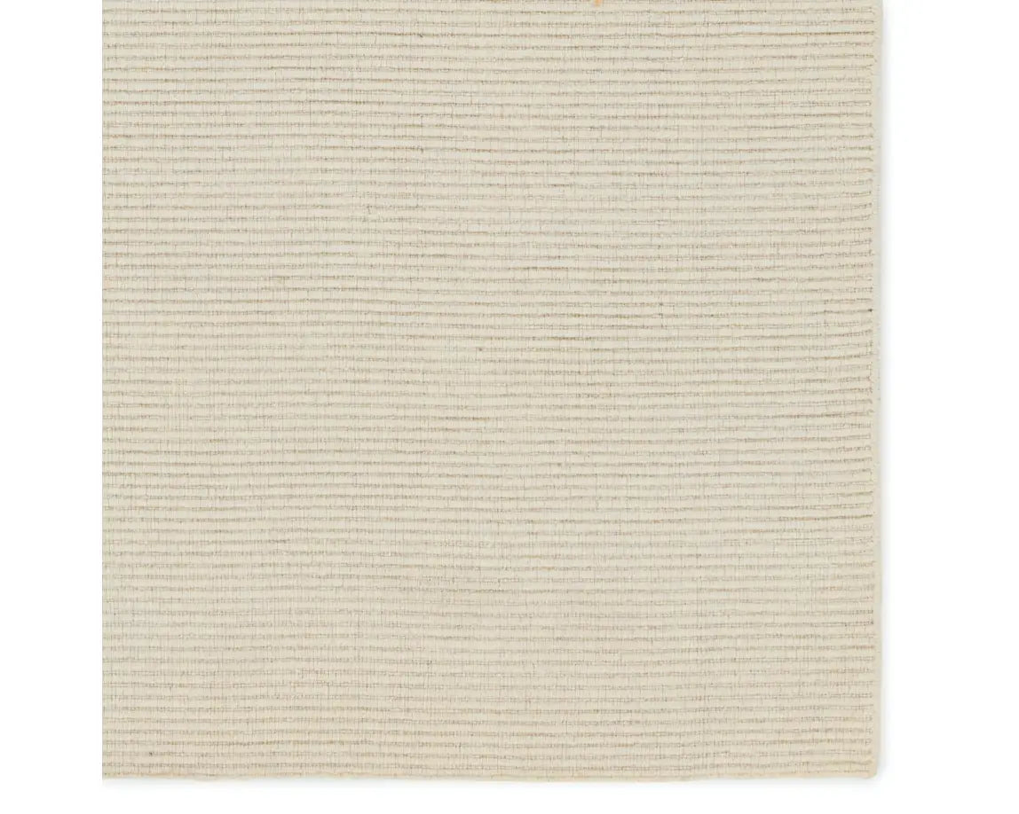 A beige area rug with a textured weave, laid out flat.