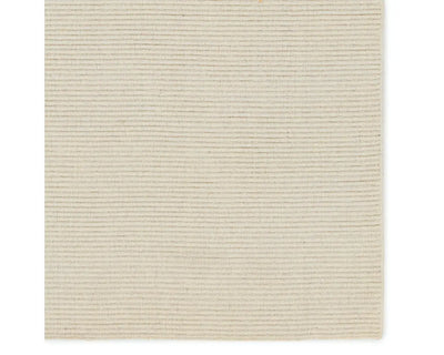 A beige area rug with a textured weave, laid out flat.