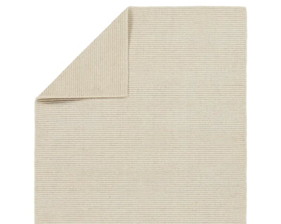 A beige area rug with a textured weave, laid out flat.
