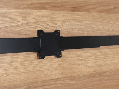 Black metal bracket on a wooden surface