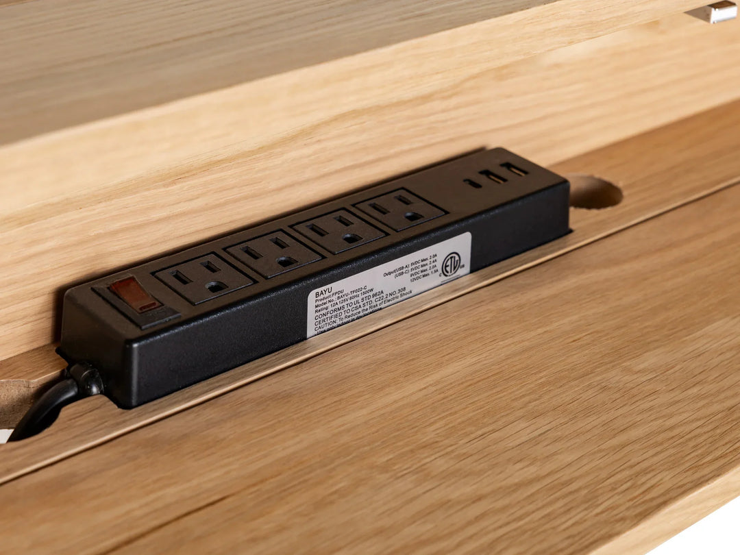 Power strip with multiple outlets embedded in a wooden surface