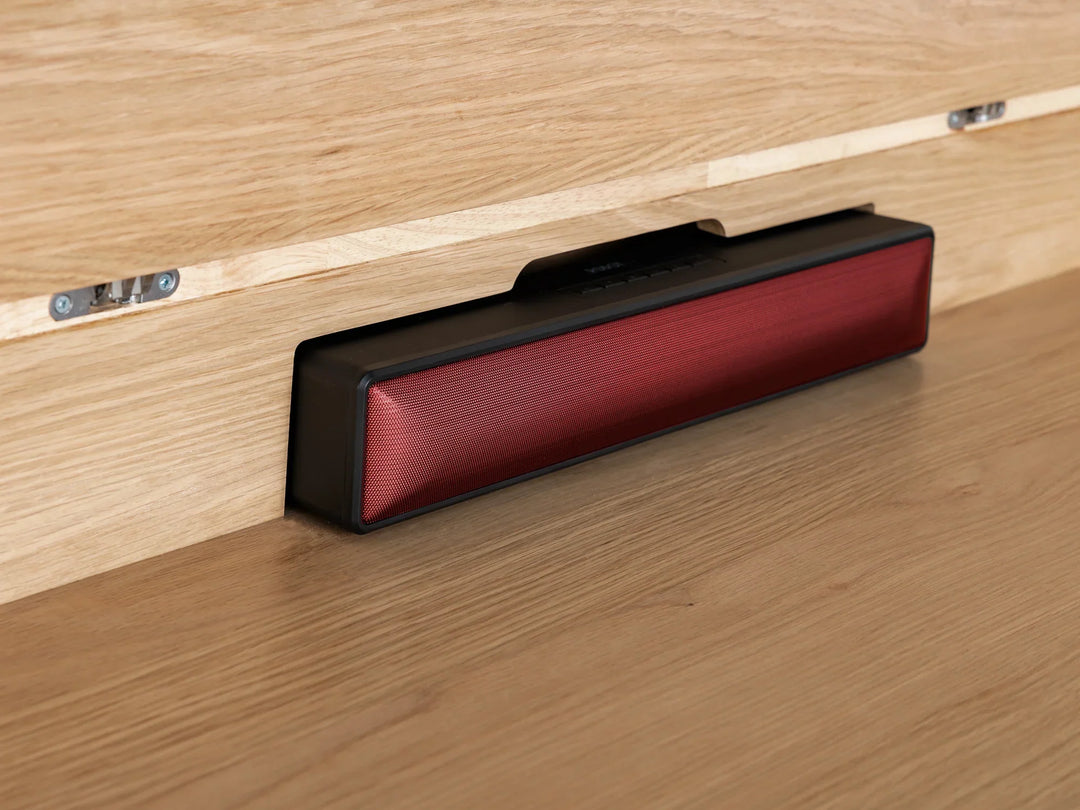 Red and black rectangular object on a wooden surface